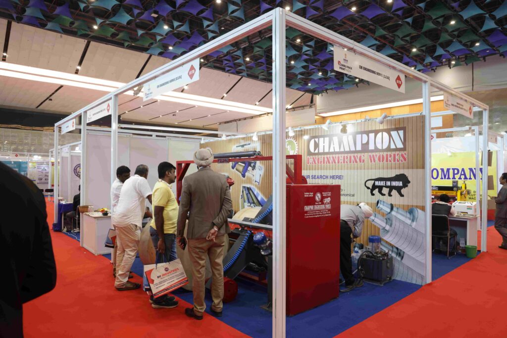Exhibitors showcasing packaging machines at Corru Pack Print India event